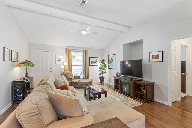 1304 Mallard Dr, Franklin, TN 37064 - living area with ceiling fan, visible vents, wood finished floors, vaulted ceiling with beams, and baseboards