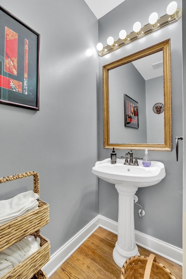 bathroom featuring baseboards and wood finished floors