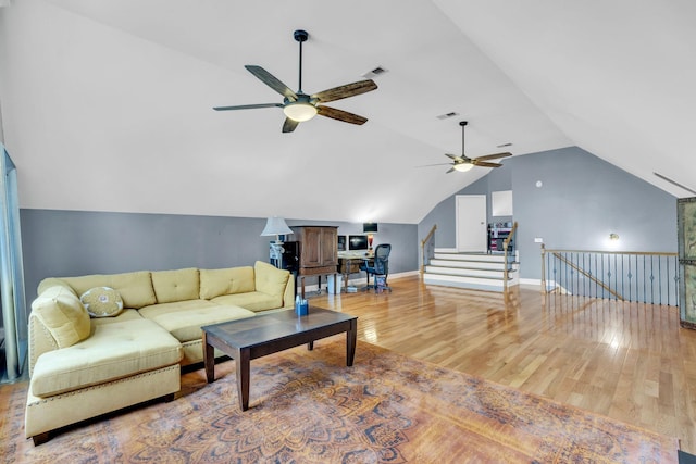 living area featuring light wood-style floors, lofted ceiling, a ceiling fan, and visible vents