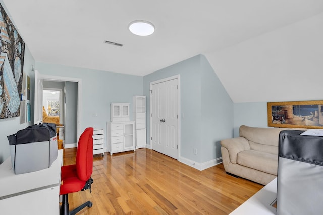 office featuring visible vents, baseboards, and wood finished floors