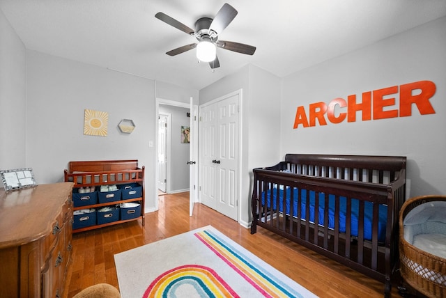 116 Dave Dr, Clarksville, TN 37042 - bedroom featuring a closet, baseboards, a crib, ceiling fan, and wood finished floors