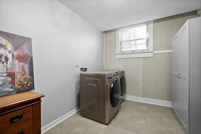 116 Dave Dr, Clarksville, TN 37042 - clothes washing area featuring washing machine and clothes dryer, a textured ceiling, baseboards, and cabinet space