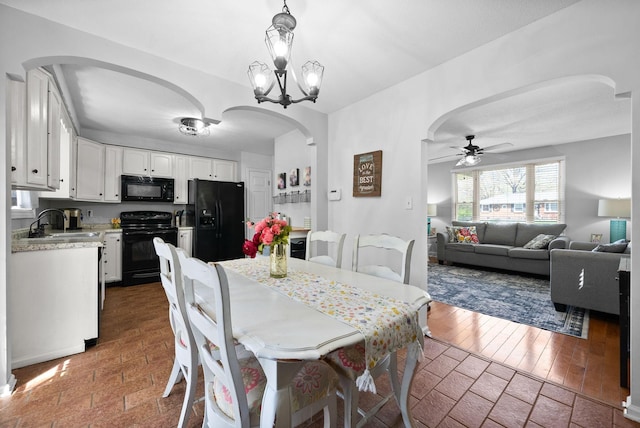 116 Dave Dr, Clarksville, TN 37042 - dining space with arched walkways and ceiling fan with notable chandelier