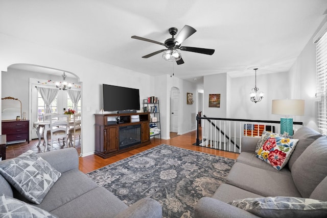 116 Dave Dr, Clarksville, TN 37042 - living area with arched walkways, wood finished floors, ceiling fan with notable chandelier, and baseboards