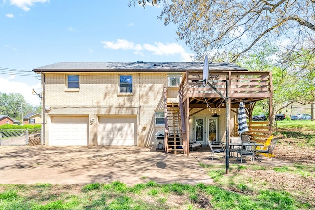116 Dave Dr, Clarksville, TN 37042 - back of house featuring a wooden deck, stairway, brick siding, french doors, and a garage