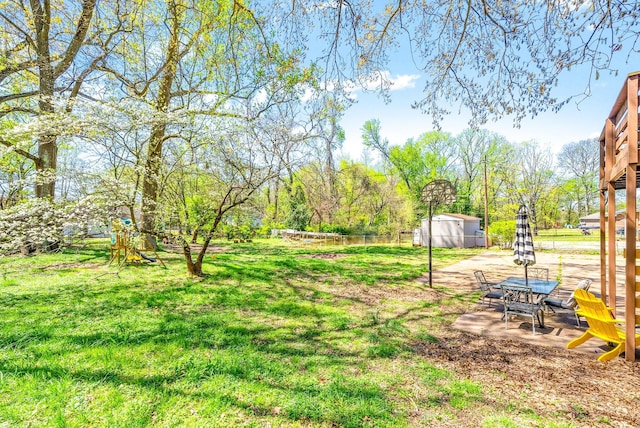 116 Dave Dr, Clarksville, TN 37042 - view of yard featuring a patio, an outdoor structure, fence, and a storage unit