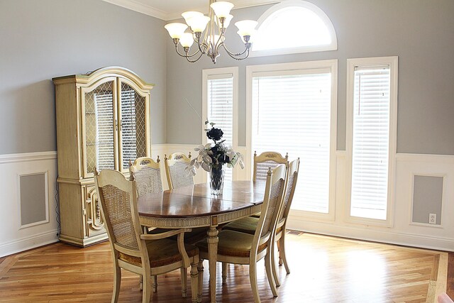 4023 Whites Creek Pike, Whites Creek, TN 37189 - dining space with a chandelier, wainscoting, crown molding, healthy amount of natural light, and light wood-type flooring