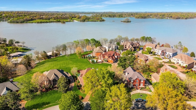 drone / aerial view featuring a water view and a residential view