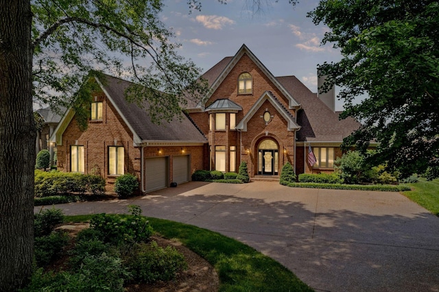 4157 Brandywine Pointe Blvd, Old Hickory, TN 37138 - view of front of home featuring brick siding, a chimney, driveway, a garage, and a shingled roof