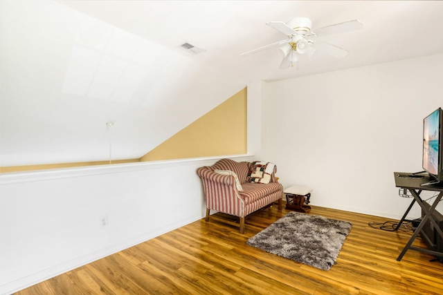 sitting room featuring visible vents, ceiling fan, baseboards, and wood finished floors