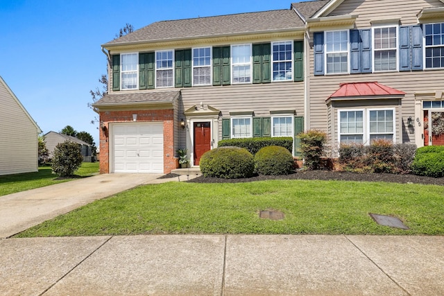 multi unit property featuring a front yard, an attached garage, brick siding, driveway, and roof with shingles