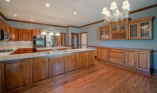 107 Geers Ct, Lebanon, TN 37087 - kitchen featuring stainless steel appliances, light wood-style floors, a sink, and light stone counters