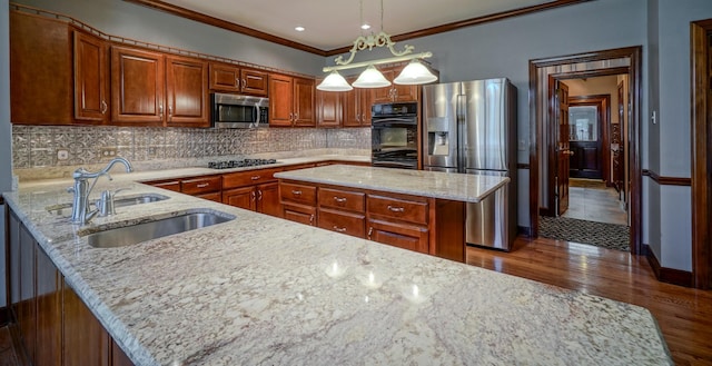 107 Geers Ct, Lebanon, TN 37087 - kitchen featuring a sink, brown cabinetry, appliances with stainless steel finishes, and light stone counters