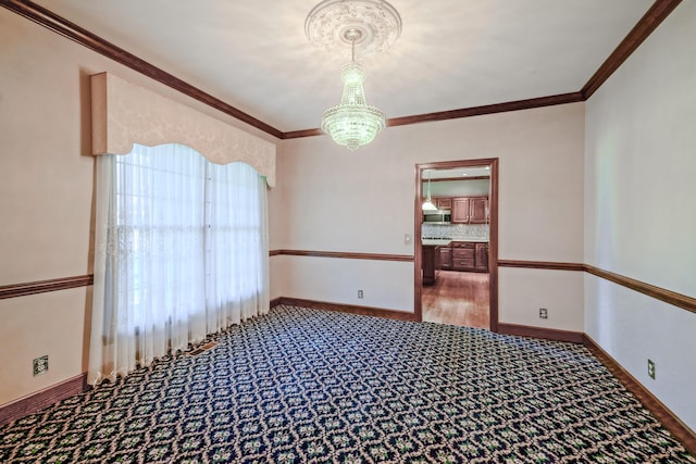 107 Geers Ct, Lebanon, TN 37087 - unfurnished room with crown molding, baseboards, carpet flooring, and an inviting chandelier