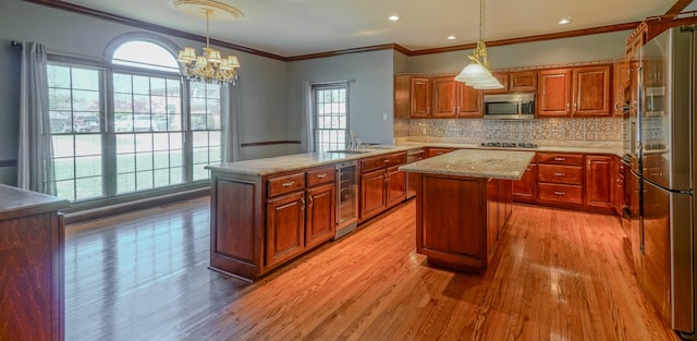 107 Geers Ct, Lebanon, TN 37087 - kitchen featuring a kitchen island, light wood-style floors, brown cabinets, appliances with stainless steel finishes, and beverage cooler