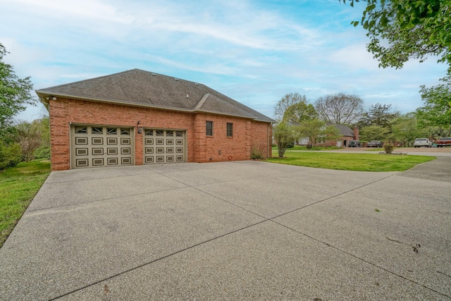 107 Geers Ct, Lebanon, TN 37087 - view of side of home featuring a shingled roof, a yard, a garage, concrete driveway, and brick siding