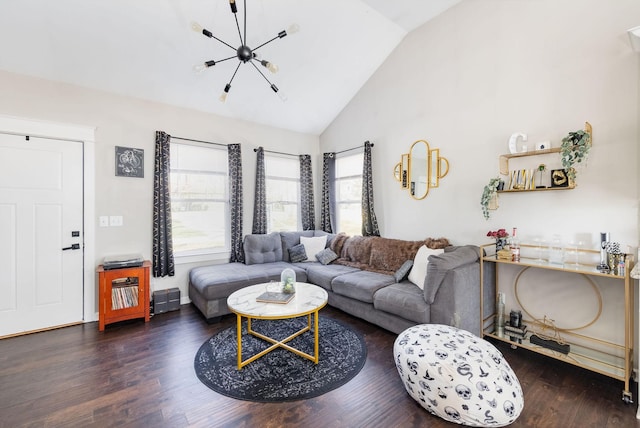 living area with high vaulted ceiling, an inviting chandelier, and wood finished floors