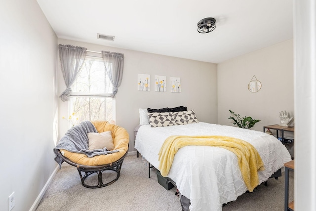 carpeted bedroom featuring visible vents and baseboards