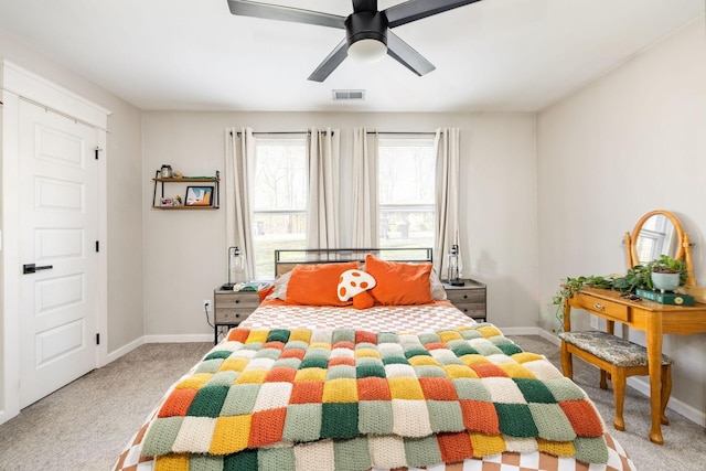 carpeted bedroom featuring visible vents, baseboards, and a ceiling fan