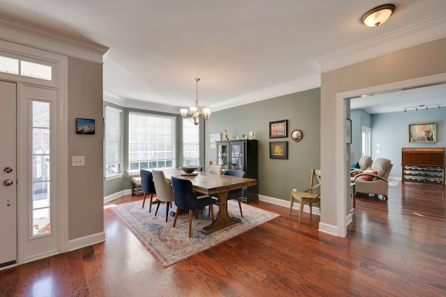 dining space with a chandelier, dark wood-type flooring, baseboards, and crown molding