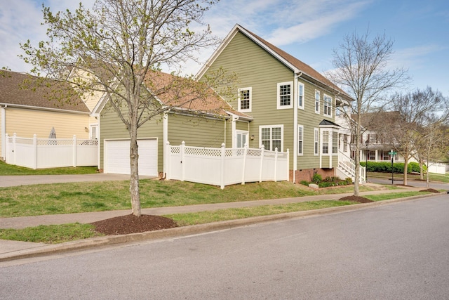 view of front of property with concrete driveway, fence, and a garage