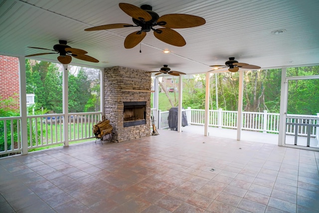 view of patio / terrace featuring a stone fireplace