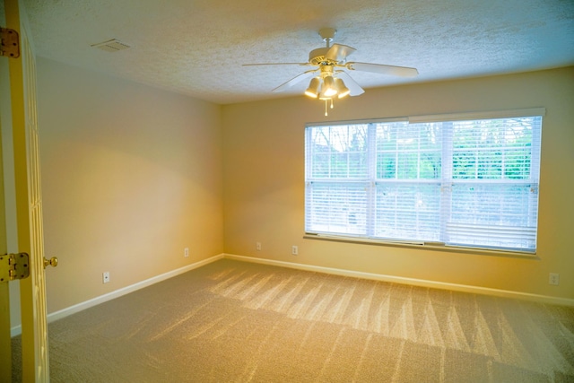 unfurnished room with baseboards, a textured ceiling, and carpet floors