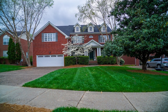 view of front of home with brick siding, driveway, a front lawn, and a garage