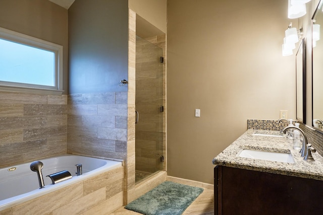 full bathroom with a sink, a bath, a shower stall, and double vanity