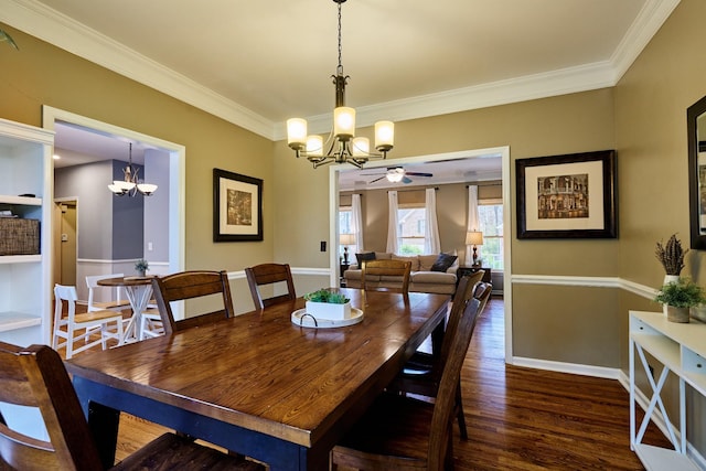 dining space with crown molding, ceiling fan with notable chandelier, baseboards, and dark wood finished floors