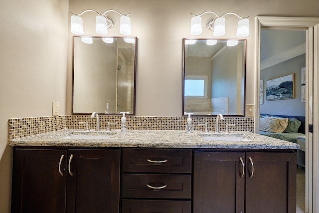 bathroom with tasteful backsplash, ensuite bathroom, and a sink