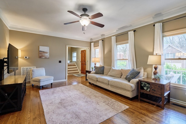 living area with wood finished floors, ceiling fan, visible vents, and plenty of natural light