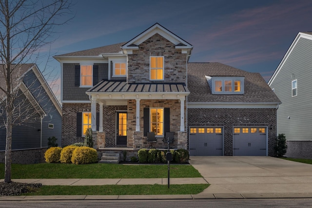 craftsman-style house featuring brick siding, a porch, stone siding, and concrete driveway
