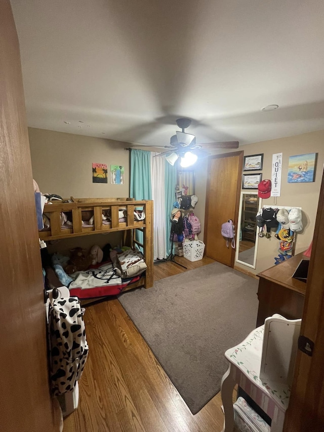 living room featuring ceiling fan and wood finished floors