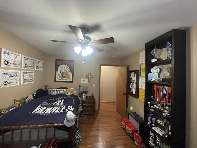 bedroom with a ceiling fan and wood finished floors