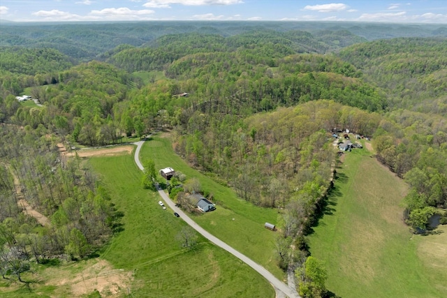 birds eye view of property with a wooded view