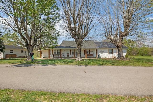 ranch-style home featuring a front yard and a porch