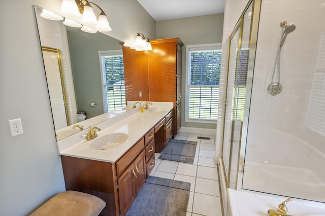 full bathroom with a shower stall, toilet, a sink, tile patterned floors, and double vanity