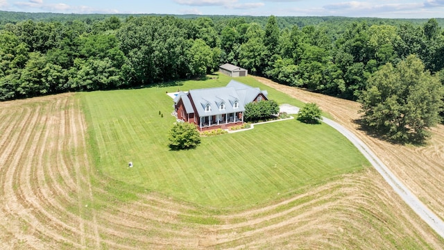 aerial view featuring a view of trees and a rural view