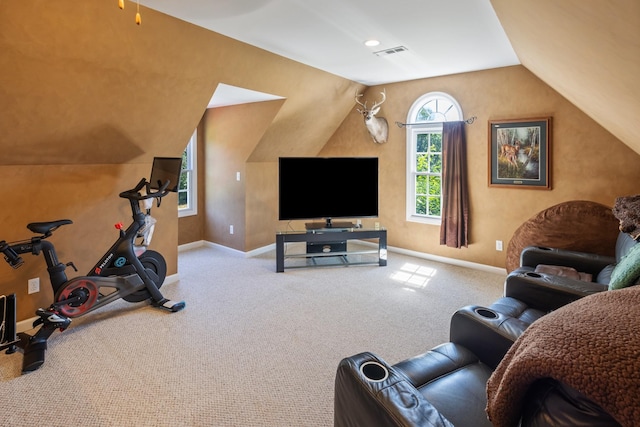 exercise area featuring baseboards, vaulted ceiling, visible vents, and carpet floors