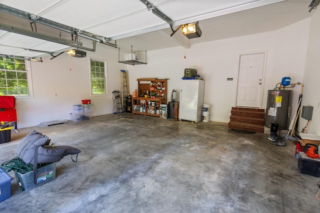 garage with a garage door opener, freestanding refrigerator, and water heater