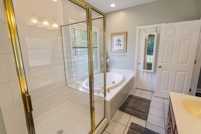 bathroom featuring a shower stall, a jetted tub, vanity, and tile patterned flooring