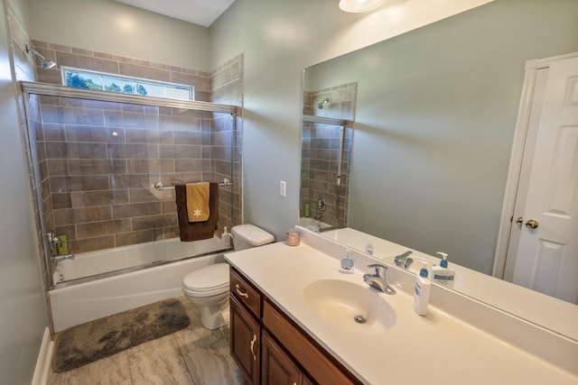 full bath featuring shower / bath combination with glass door, vanity, and toilet