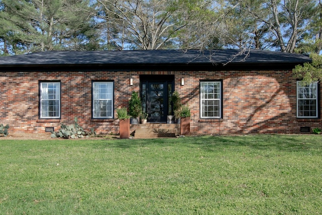 ranch-style house featuring a front yard, brick siding, and crawl space