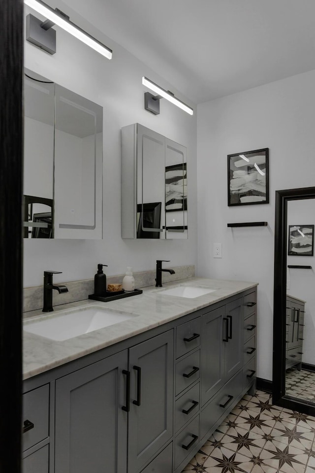 bathroom with a sink, tile patterned floors, and double vanity