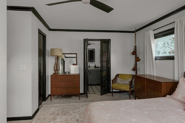 bedroom with baseboards, ornamental molding, light carpet, ensuite bath, and ceiling fan