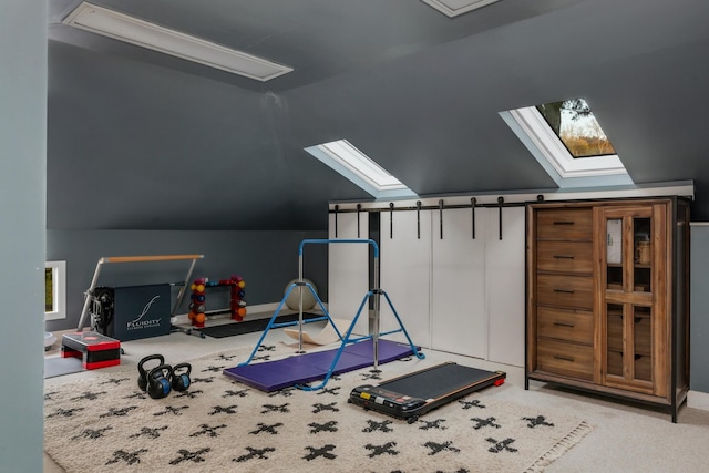 workout room featuring vaulted ceiling with skylight and carpet
