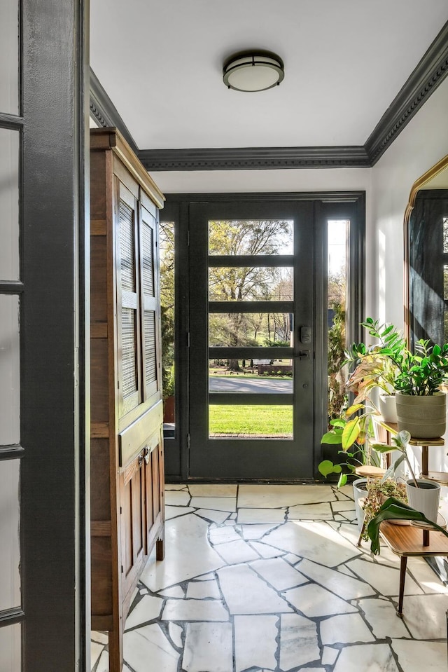 doorway with crown molding and stone tile flooring
