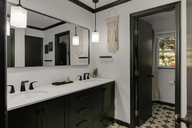 full bathroom featuring baseboards, a sink, crown molding, double vanity, and tile patterned floors