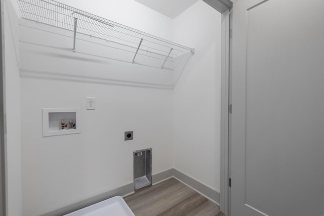 washroom featuring wood finished floors, baseboards, hookup for a washing machine, and electric dryer hookup